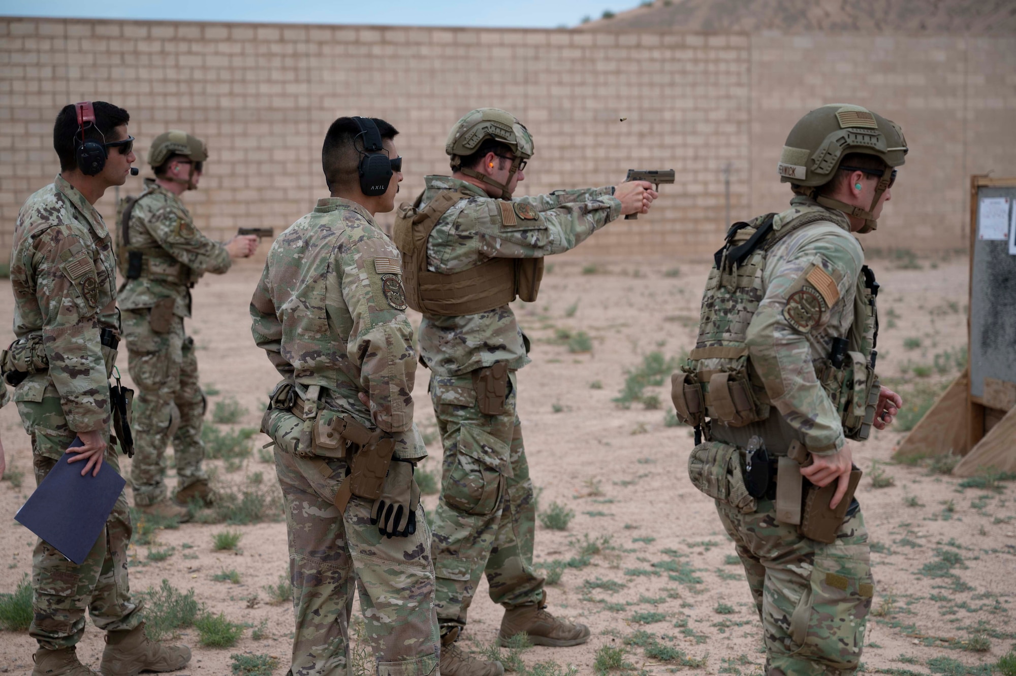 Airmen from the 49th Security Forces Squadron fire their weapons as part of the marksmanship portion of the Special Reaction Team tryouts at Holloman Air Force Base, New Mexico, June 9, 2023. The candidates were evaluated on their marksmanship skills to determine who would be selected for official SRT training at Fort Leonard Wood, Missouri. (U.S. Air Force photo by Airman 1st Class Michelle Ferrari)