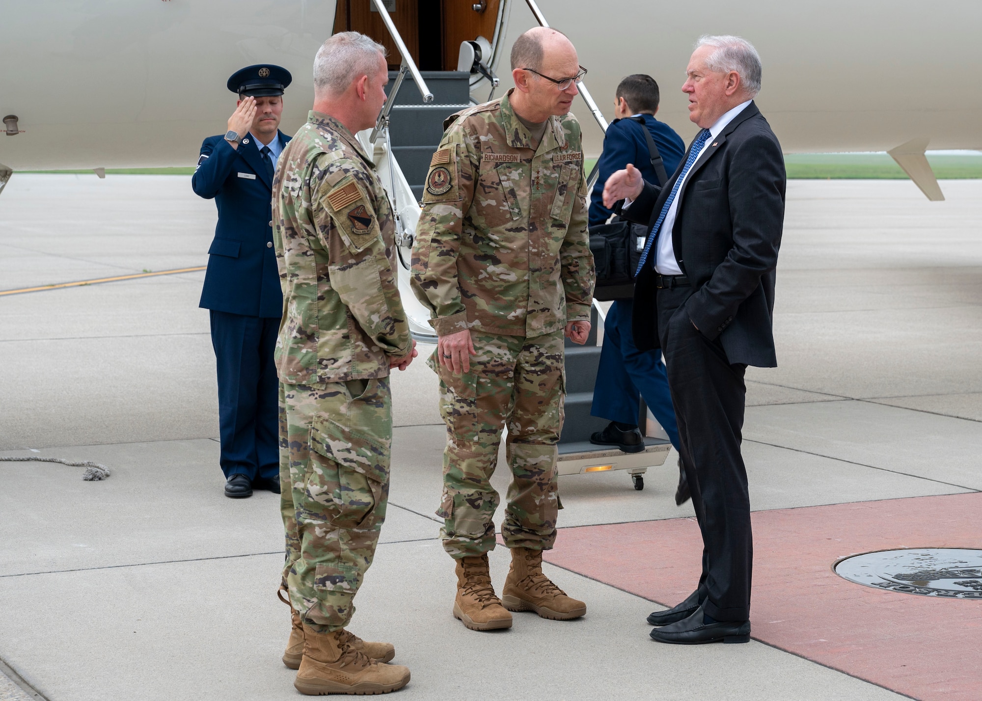 Gen. Duke Richardson, Air Force Materiel Command commander (middle), greets Secretary of the Air Force Frank Kendall on the flightline at Wright-Patterson Air Force Base, Ohio, June 27, 2023.