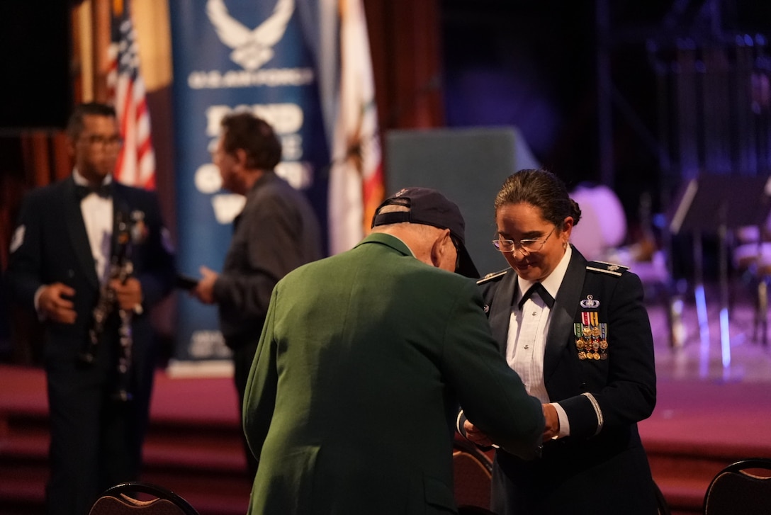 Lt Col Moore Urrutia speaks with veteran after a Concert Band performance in Oakland, CA