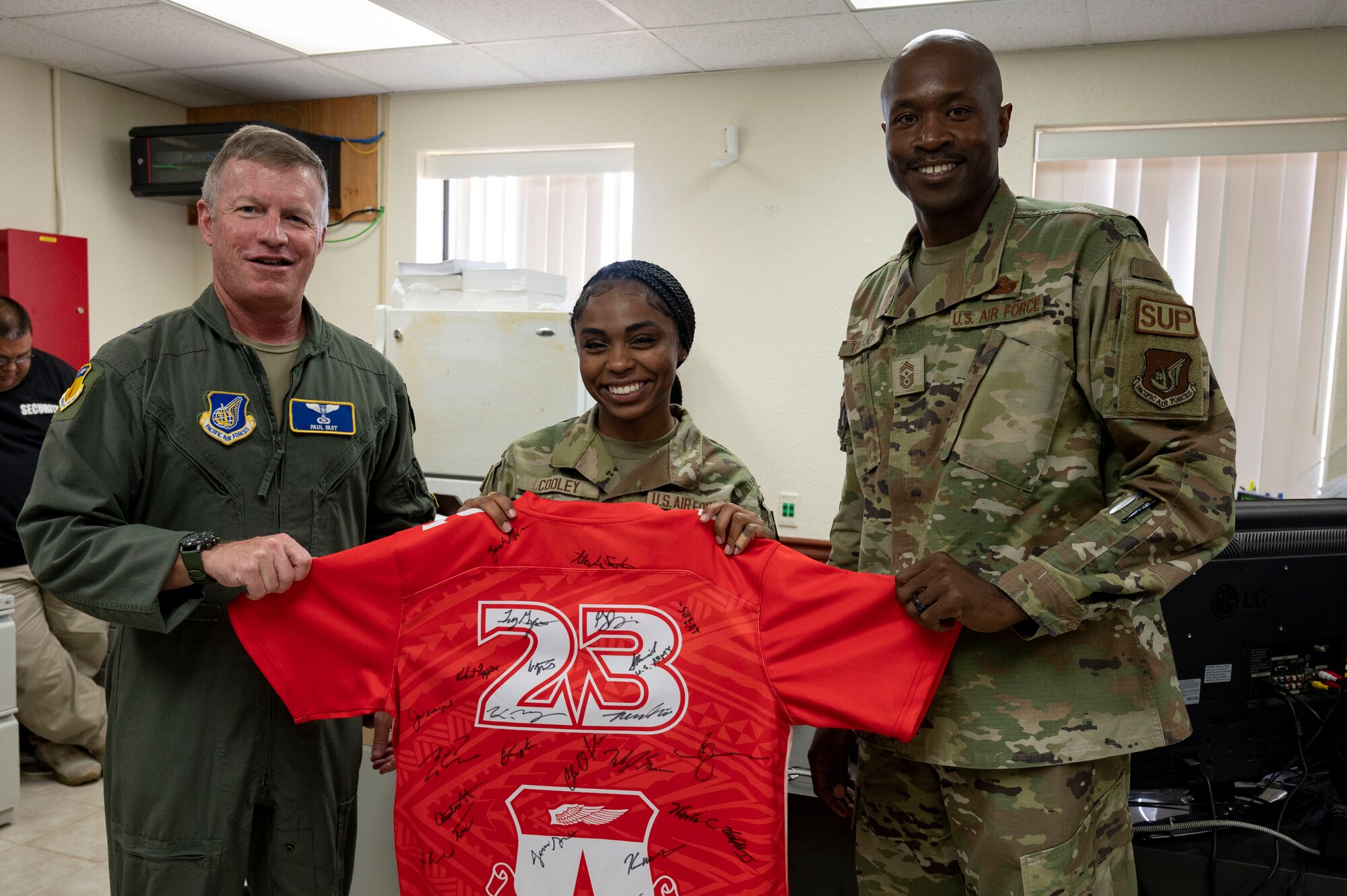 U.S. Air Force Airman 1st Class Kioni Cooley, an installation access clerk assigned to the 36th Security Forces Squadron, receives the Linebacker of the Week Award from U.S. Air Force Brig. Gen. Paul Fast, commander of the 36th Wing, and U.S. Air Force Chief Master Sgt. Nicholas Taylor, the command chief of the 36th Wing, at Andersen Air Force Base, Guam, June 21, 2023. The Team Andersen Linebacker of the Week recognizes outstanding enlisted, officer, civilian and total force personnel who have had an impact on achieving Team Andersen’s mission, vision and priorities. (U.S. Air Force photo by Airman 1st Class Emily Saxton)