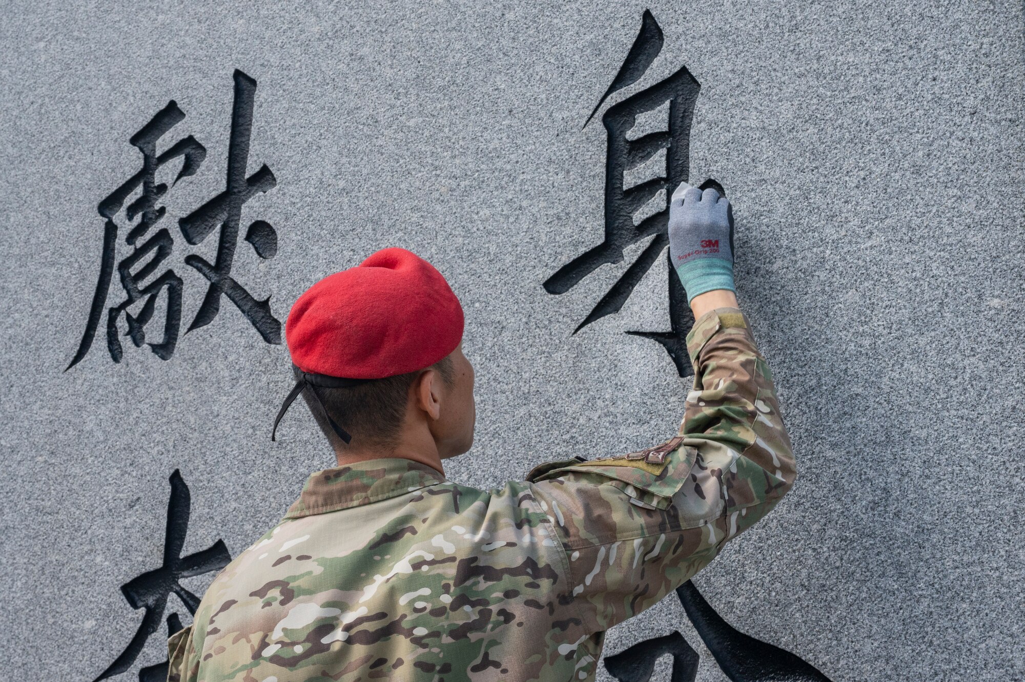 A Republic of Korea Air Force combat controller cleans a memorial at Osan Air Base, ROK, June 22, 2023. U.S. and ROK troops teamed up to clean two memorials on base for the 73rd anniversary of the Korean War. (U.S. Air Force photo by Senior Airman Aaron Edwards)