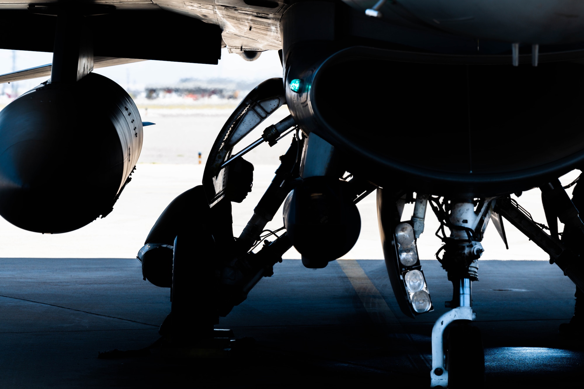 A U.S. Air Force crew chief assigned to the 56th Fighter Wing examines an F-16 Fighting Falcon after an Instructor Pilot War Day exercise, June 23, 2023, at Luke Air Force Base, Arizona.