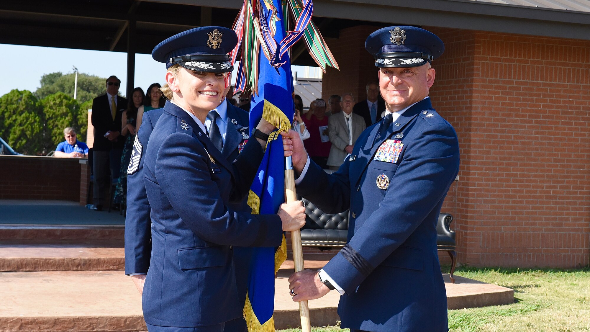 Maj. Gen. Michelle Edmondson, Second Air Force commander, passes the guidon to Brig. Gen. George T.M. Dietrich III during the 82nd Training Wing Change of Command Ceremony at Sheppard Air Force Base, Texas, June 27, 2023.