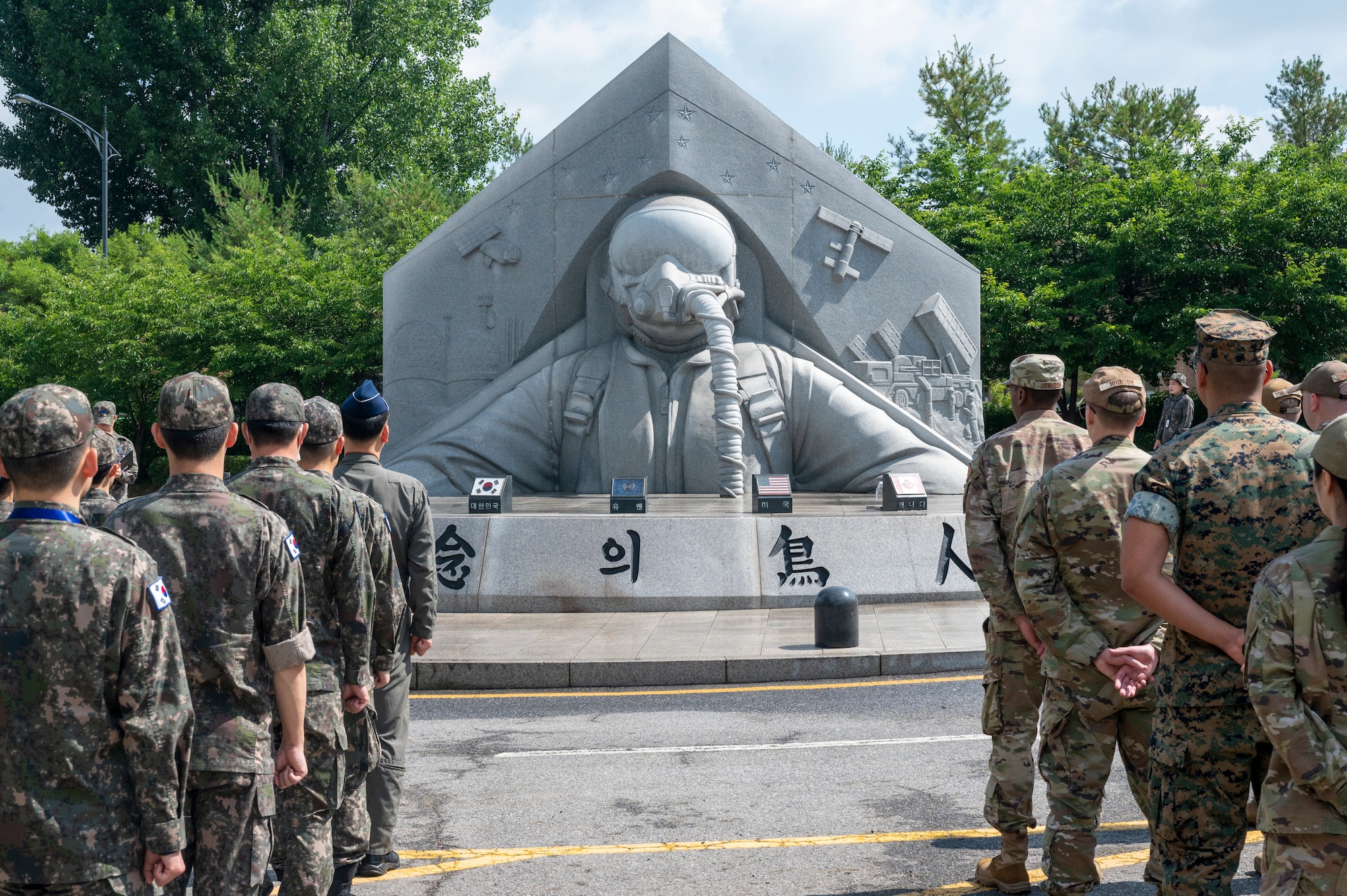 U.S. and Republic of Korea troops stand in formation during a memorial ceremony at Osan Air Base, ROK, June 22, 2023. Before the ceremony, the troops cleaned the memorial site with brushes, brooms and wipes to pay respects to those who made the ultimate sacrifice during the Korean War. (U.S. Air Force photo by Senior Airman Aaron Edwards)