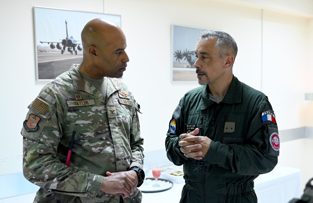 U.S. Air Force Col. Terence G. Taylor, left, 380th Air Expeditionary Wing commander, and Général de brigade aérienne Marc Le Bouil from the French Air and Space Force talk after a mission brief for Pégase 2023 at Al Dhafra Air Base, United Arab Emirates, June 25, 2023. . During Pégase 2023, the French Air and Space Force are deploying 19 aircraft and 320 personnel to the Indo-Pacific region until Aug. 3, 2023. While there, French forces are scheduled to participate in multinational, large force exercises led by the U.S. Air Force and held with regional partners. (U.S. Air Force photo by Tech. Sgt. Alex Fox Echols III)