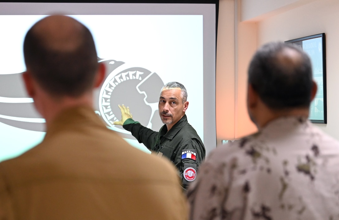 Général de brigade aérienne Marc Le Bouil from the French Air and Space Force briefs the Pégase 2023 mission to members of the United Arab Emirates, United States and French militaries at Al Dhafra Air Base, United Arab Emirates, June 25, 2023. During Pégase 2023, the French Air and Space Force are deploying 19 aircraft and 320 personnel to the Indo-Pacific region until Aug. 3, 2023. While there, French forces are scheduled to participate in multinational, large force exercises led by the U.S. Air Force and held with regional partners. (U.S. Air Force photo by Tech. Sgt. Alex Fox Echols III)