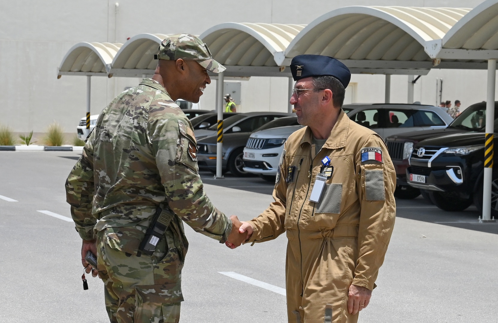 U.S. Air Force Col. Terence G. Taylor, left, 380th Air Expeditionary Wing commander, and Lieutenant-colonel Bruno from the French Air and Space Force meet prior to a mission brief for Pégase 2023 at Al Dhafra Air Base, United Arab Emirates, June 25, 2023. During Pégase 2023, the French Air and Space Force are deploying 19 aircraft and 320 personnel to the Indo-Pacific region until Aug. 3, 2023. While there, French forces are scheduled to participate in multinational, large force exercises led by the U.S. Air Force and held with regional partners. (U.S. Air Force photo by Tech. Sgt. Alex Fox Echols III)