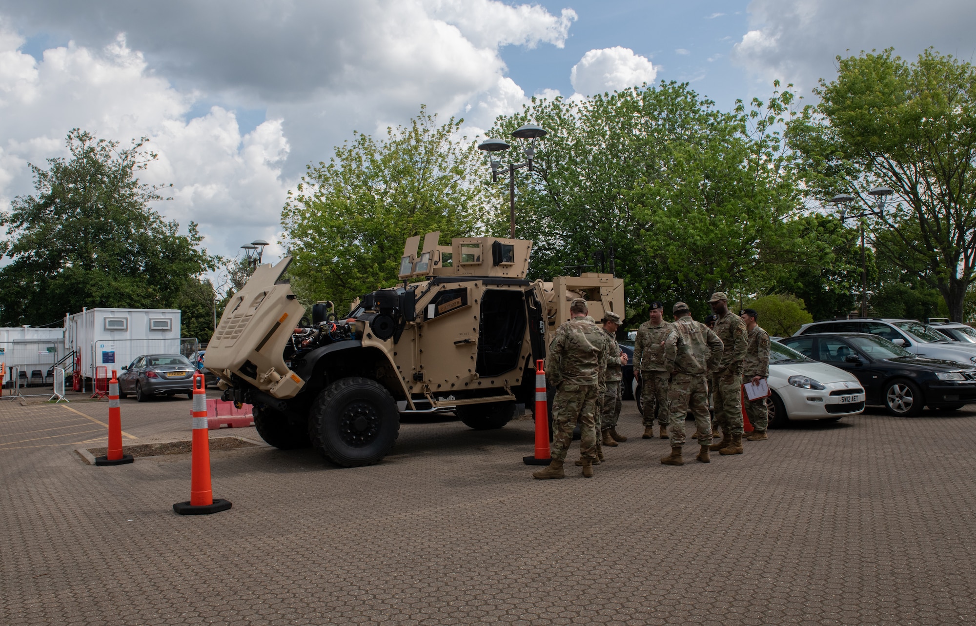 U.S. Air Force Airmen assigned to the 48th Security Forces Squadron and the 48th Logistics Readiness Squadron discuss the new Joint Light Tactical Vehicle on RAF Lakenheath, England, June 22, 2023. The new JLTVs provide a reliable weapon system platform to achieve fire security, which will add to the 48th Fighter Wing’s readiness priority. (U.S. Air Force photo by Airman Delanie Brown)