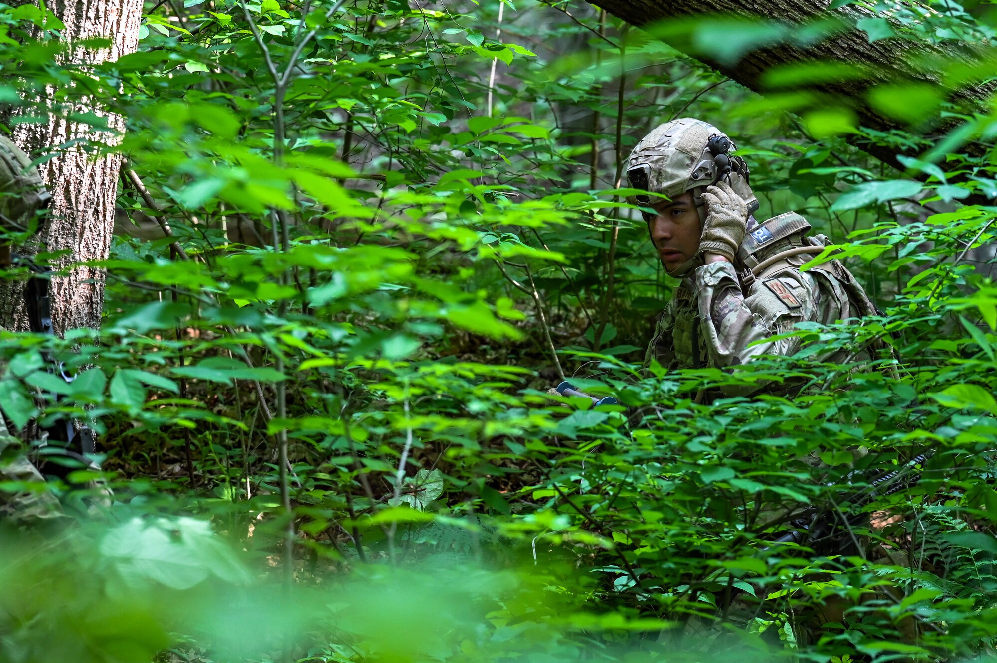 Senior Airman Felix Barboza, a Defender assigned to the 301st Security Forces Squadron, Carswell Field, Naval Air Station Joint Reserve Base Fort Worth, Texas, receives radio communication through his helmet on June 15, 2023, at Camp James A. Garfield Joint Military Training Center, Ohio.