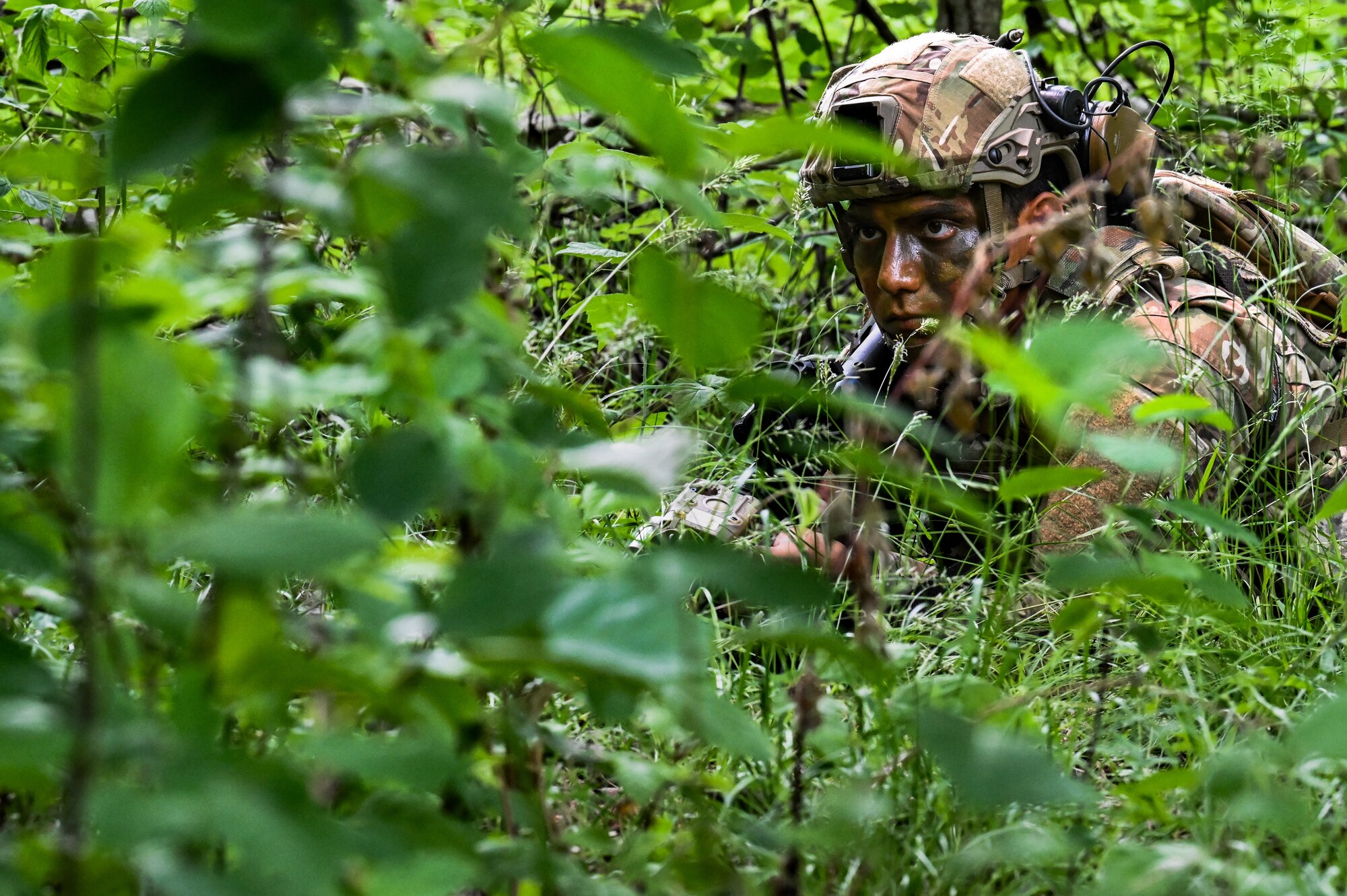 Senior Airman Aaron Meza, a Defender assigned to the 301st Security Forces Squadron, Carswell Field, Naval Air Station Joint Reserve Base Fort Worth, Texas, lies in a prone position during a training exercise on June 15, 2023, at Camp James A. Garfield Joint Military Training Center, Ohio.