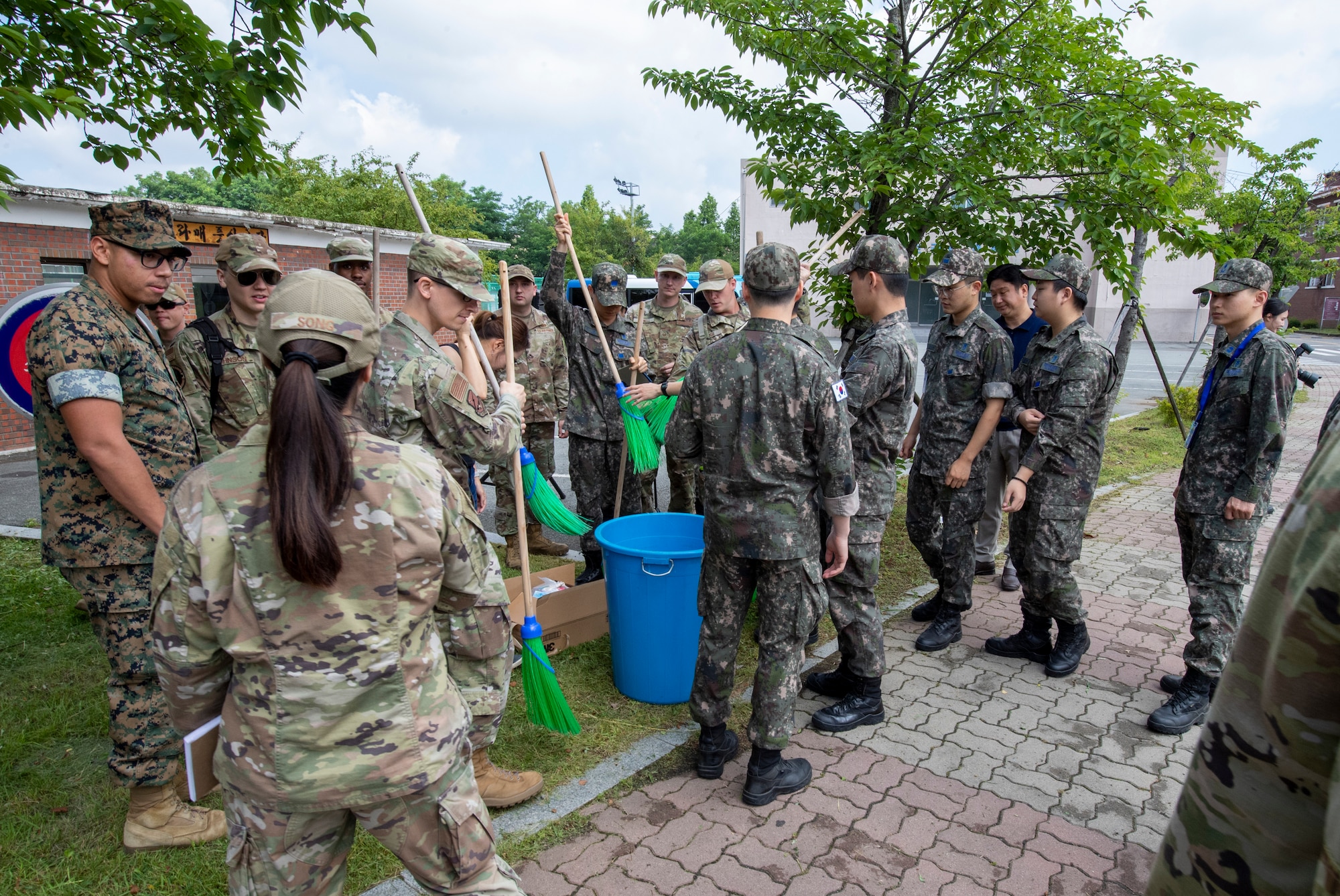 U.S. and Republic of Korea troops grab equipment to clean a memorial sculpture at Osan Air Base, ROK, June 22, 2023. U.S. and ROK troops teamed up to clean two memorials on base in honor of the 73rd anniversary of the Korean War. (U.S. Air Force photo by Senior Airman Aaron Edwards)