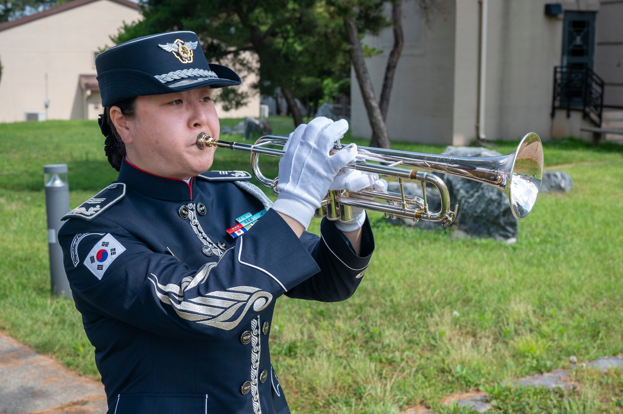 A Republic of Korea Air Force band member plays Taps during a memorial ceremony at Osan Air Base, ROK, June 22, 2023. The 24-note bugle call is played at military funerals and memorial services to honor the sacrifice of fallen service members. (U.S. Air Force photo by Senior Airman Aaron Edwards)