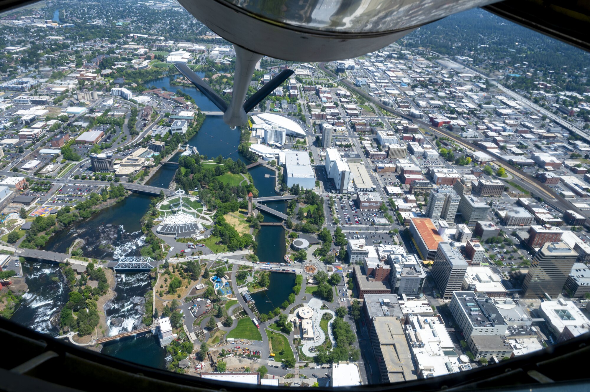 A KC-135 Stratotanker assigned to Fairchild Air Force Base, Washington, flies over downtown Spokane as part of Operation Centennial Contact June 27, 2023. The movement, which also included flights over Yellowstone National Park, Mount Rushmore and Glacier National Park, was part of Air Mobility Command’s celebration of 100 years air refueling operations and demonstrated the 92nd Air Refueling Wing’s global reach capabilities. Since its inception in 1923, air refueling has become a crucial component of military and civilian aviation operations around the world by extending the range and endurance of aircraft and enabling them to complete missions that would otherwise be impossible or require multiple stops. As a result, this capability is essential for strategic and tactical operations, as well as humanitarian relief efforts in support of AMC, U.S. Transportation Command and Department of Defense priorities. (U.S. Air Force photo by Staff Sgt. Lawrence Sena)