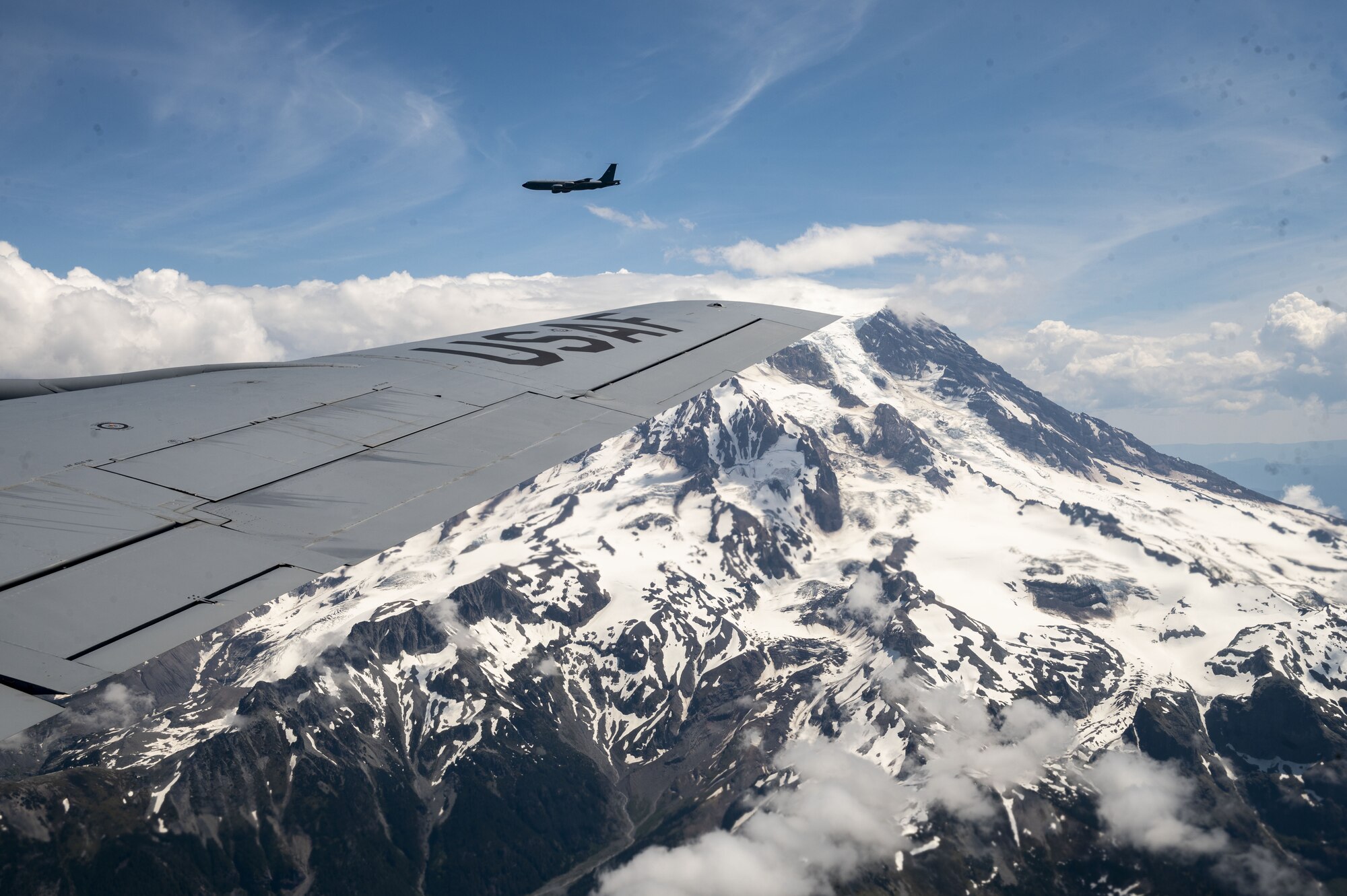 KC-135 Stratotankers assigned to Fairchild Air Force Base, Washington, fly over Mount Rainier, Washington, as part of Operation Centennial Contact June 27, 2023. The movement, which also included flights over Yellowstone National Park, Mount Rushmore and Glacier National Park, was part of Air Mobility Command’s celebration of 100 years air refueling operations and demonstrated the 92nd Air Refueling Wing’s global reach capabilities. Since its inception in 1923, air refueling has become a crucial component of military and civilian aviation operations around the world by extending the range and endurance of aircraft and enabling them to complete missions that would otherwise be impossible or require multiple stops. As a result, this capability is essential for strategic and tactical operations, as well as humanitarian relief efforts in support of AMC, U.S. Transportation Command and Department of Defense priorities. (U.S. Air Force photo by Staff Sgt. Lawrence Sena)
