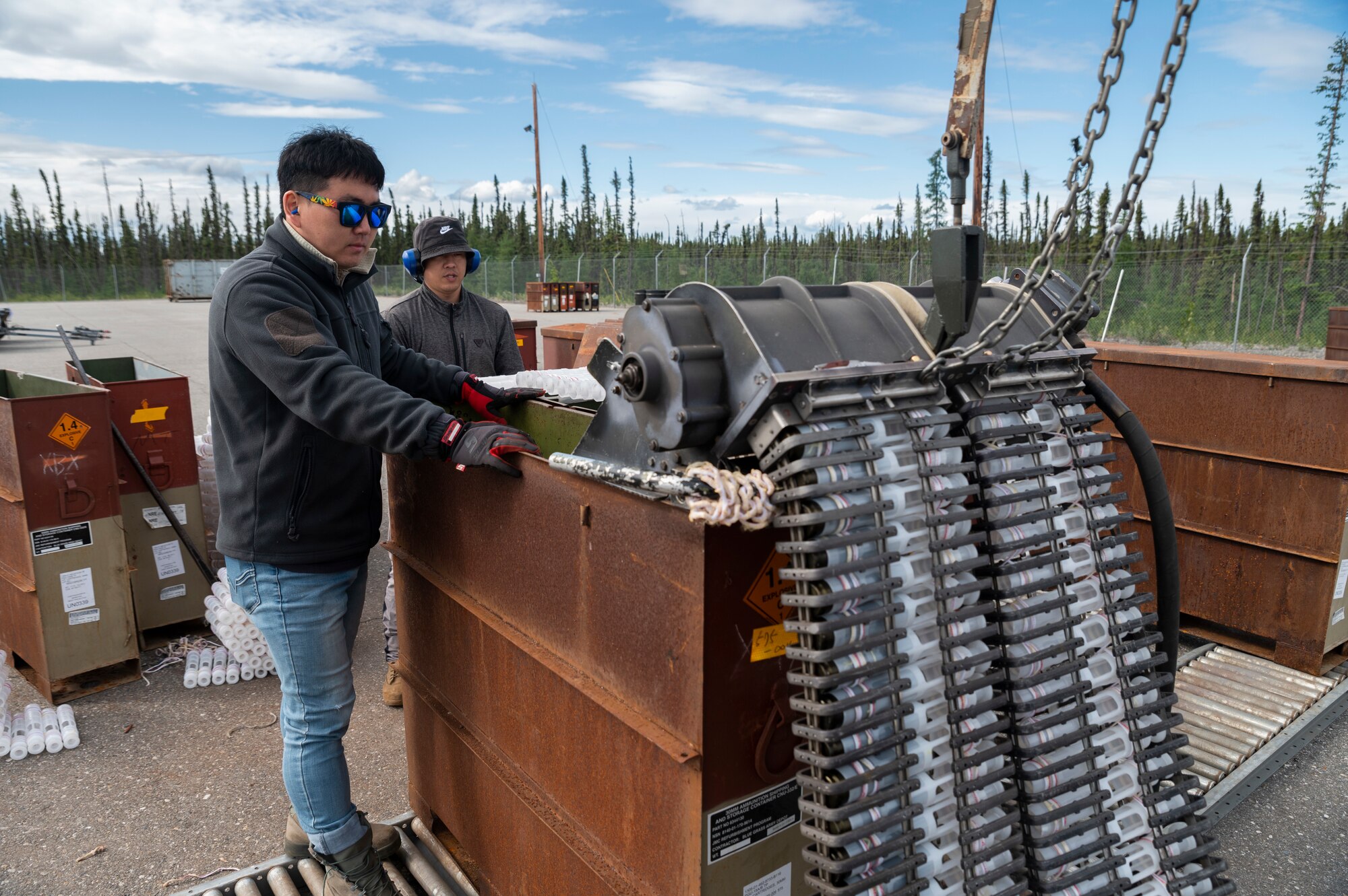 Tong Chu Paek and Jin Choi, 51st Munitions Squadron explosive operator renovation technician, Osan Air Base, Republic of Korea, operate a 30mm munitions loader during Red Flag Alaska (RF-A) 23-2 at Eielson Air Force Base, Alaska, June 12, 2023.