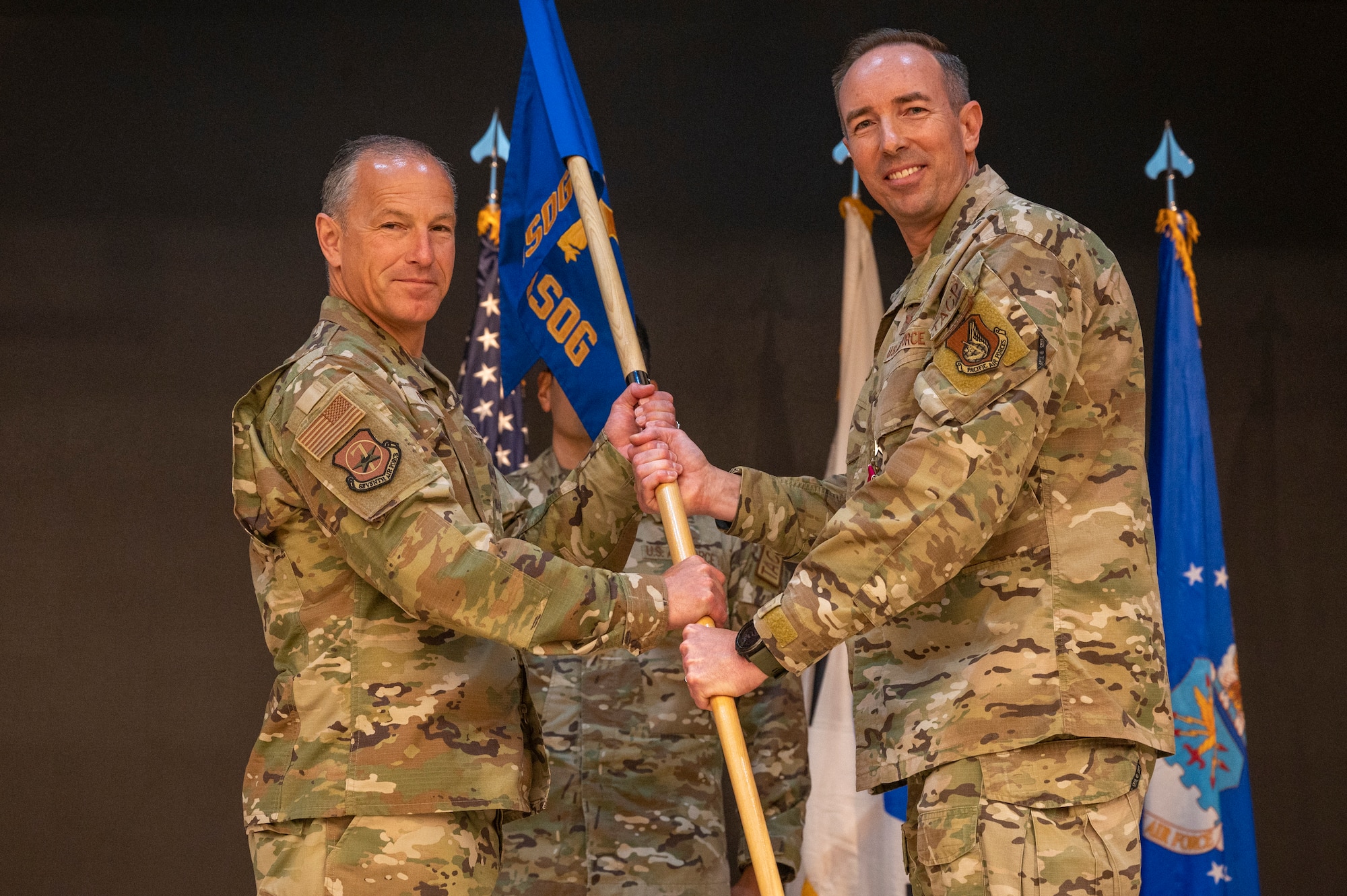 U.S. Air Force Lt. Gen. Scott Pleus, left, 7th Air Force commander, receives the guidon from Col. Scott Morgan, 607th Air Support Operations Group outgoing commander, at Osan Air Base, Republic of Korea, June 26, 2023. In a change of command ceremony, the guidon symbolizes the transfer of command, the authority and responsibility associated with it.  (U.S. Air Force photo by Senior Airman Aaron Edwards)
