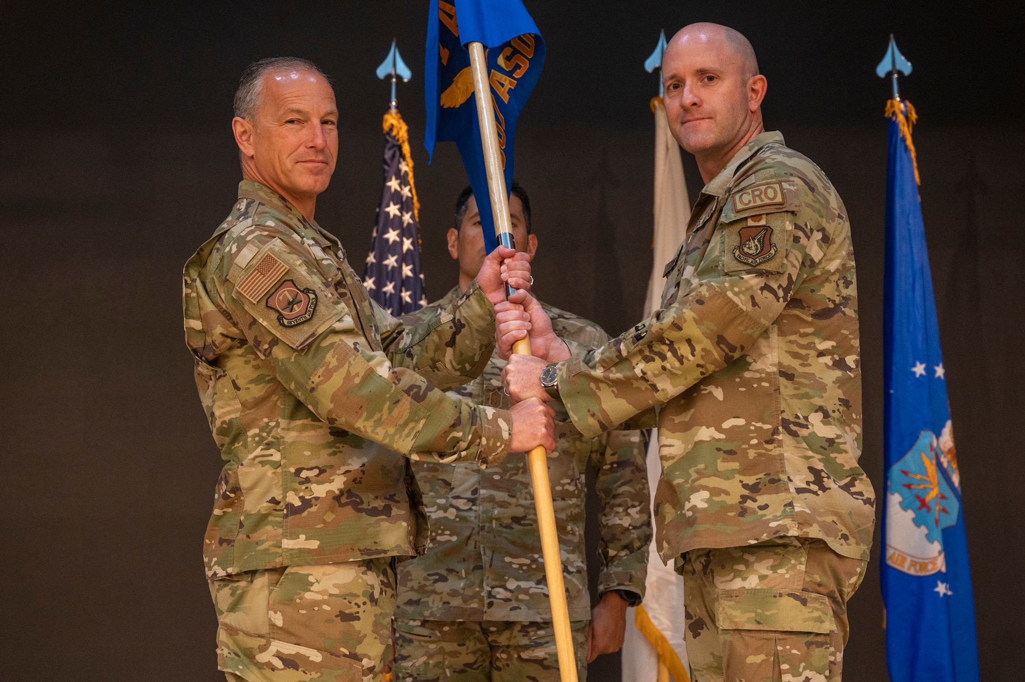 U.S. Air Force Lt. Gen. Scott Pleus, left, 7th Air Force commander, presents the guidon to Col. Patrick Lowe, 607th Air Support Operations Group incoming commander, as a symbol of his taking command  at Osan Air Base, Republic of Korea, June 26, 2023. Prior to taking command, Lowe served as chief, personnel recovery division for headquarters Air Combat Command at Joint Base Langley-Eustis, Virginia. (U.S. Air Force photo by Senior Airman Aaron Edwards)