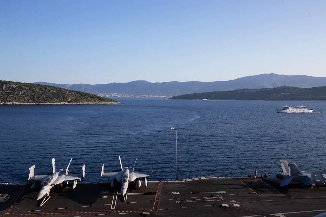 Planes sit on the deck of an aircraft carrier.