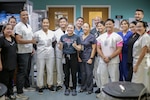 Combat medics from the Guam National Guard and members of the Guam Memorial Hospital emergency room staff work together in the wake of Typhoon Mawar June 21, 2023.