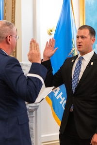 U.S. Air Force Maj. Rex Alan Star, left, Arkansas Air National Guard, issues the oath of enlistment to Tom Woods, an Oklahoma state senator, at the Oklahoma State Capitol on June 26, 2023, Oklahoma City. Woods enlisted into the Oklahoma ANG to serve beyond his congressional district and will attend Air Force basic military training and security forces technical training between state senate sessions. (U.S. Air National Guard photo by Airman Erika Chapa)