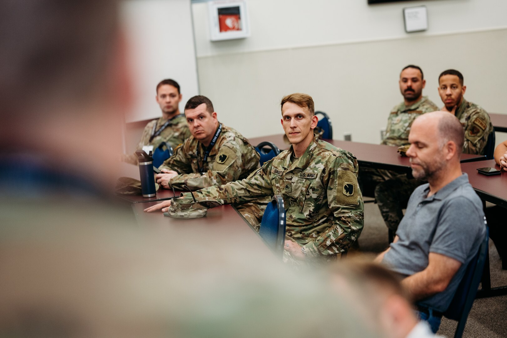 Members of the Oklahoma National Guard cyber defense team receives a mission update during Cyber Shield 2023, held at the Professional Education Center in Little Rock, Arkansas, June 10, 2023. With technology continuing to advance at an unprecedented pace along with its associated threats, members of the Oklahoma National Guard joined approximately 800 military and civilian cyber professionals from 35 states, including international partners, for this year’s Cyber Shield, June 2-16, 2023. This year's exercise, won by the Oklahoma team for the second year in a row, was centered on critical infrastructure protection, incident response, network defense with a specific tie to U.S. Transportation Systems Sector and other crucial aspects of cybersecurity. (Oklahoma National Guard photo by Master Sgt. Mireille Merilice-Roberts)