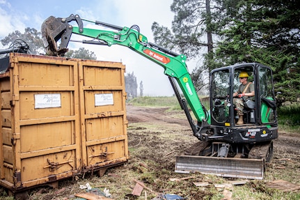 Spc. Austin Mears, a Stillwater, Oklahoma resident serving as a horizontal construction engineer with the 3120th Engineer Support Company, 120th Engineer Battalion, 90th Troop Command, Oklahoma Army National Guard, loads debris into a dumpster during renovations at the Girl Scouts of Hawaii's Camp Kilohana near Pahokuloa Training Area, Hawaii, June 14, 2023.

The Soldiers of the 3120th ESC are taking part in an Innovative Readiness Training program to improve their skills as Army engineers while providing the Girl Scout camp with improvements. (Oklahoma National Guard photo by Sgt. Anthony Jones)