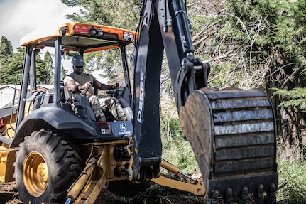 Sgt. Kevin Ishola, a Tulsa, Oklahoma resident serving as a signal support specialist with the 3120th Engineer Support Company, 120th Engineer Battalion, 90th Troop Command, Oklahoma Army National Guard, uses a heavy equipment ot remove tree debris during renovations of the Girl Scouts of Hawaii's Camp Kilohana near Pahokuloa Training Area, Hawaii, June 14, 2023.

The Soldiers of the 3120th ESC are taking part in an Innovative Readiness Training program to improve their skills as Army engineers while providing the Girl Scout camp with improvements. (Oklahoma National Guard photo by Sgt. Anthony Jones)