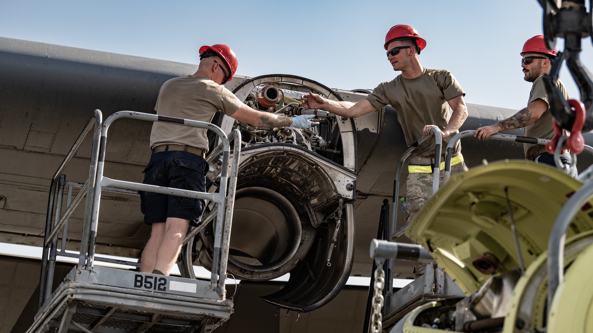 From left, Senior Airman Austin Willard, Staff Sgt. Jay Michael Rymarz, and Senior Airman Steven Garland, 386th Expeditionary Aircraft Maintenance Squadron aerospace propulsion technicians, prepare a C-130J Super Hercules to receive a new engine at Ali Al Salem Air Base, Kuwait, June 27, 2023. The 386th Air Expeditionary Wing is the primary airlift hub and gateway for delivering combat power to joint and coalition forces in the U.S. Central Command area of responsibility. (U.S. Air Force photo by Staff Sgt. Kevin Long)