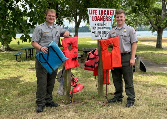Old Hickory Park Rangers Jakob Craig and Britton Dillard hang lifejackets and floatation mats for visitors to borrow while recreating June 22, 2023, at Old Hickory Lake in Hendersonville, Tennessee. (USACE Photo by: Misty Cunningham)