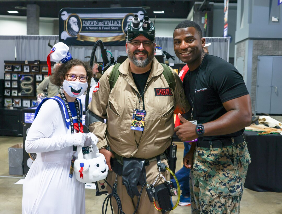 Crystal Tallierchio, left, and Wayne Carroll, center, convention goers, interact with U.S. Marine Corps Staff Sgt. Gwaltney Marshall, right, a recruiter with Recruiting Station Frederick, during Awesome Con at the Walter E. Washington Convention Center, Washington D.C., June 15, 2023. The three-day event is catered to comic book fans, movie fans, artists, and video gamers to meet and greet with comic industry professionals and celebrities. (U.S. Marine Corps photo by Cpl. Bernadette Pacheco)