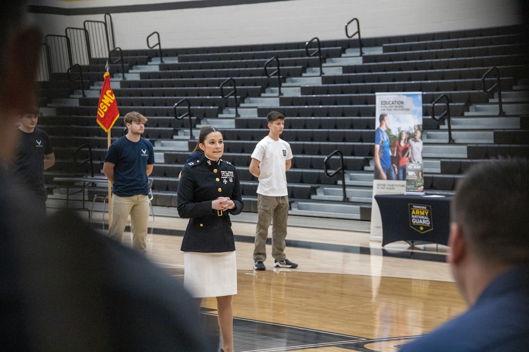 U.S. Marine Corps Capt. Shannon Johnson, center, executive officer, Recruiting Station Nashville, speaks to future service members during the Military Commitment Ceremony hosted by Mount Juliet High School in Mount Juliet, Tennessee, April 20, 2023. Students and families gathered to honor the young men and women who enlisted to serve in one of the military branches in coming months. During the ceremony, active and retired Marines spoke to the future service members, who concluded the ceremony by taking the Oath of Enlistment. (U.S. Marine Corps photo by Sgt. Andrew Hiatt)