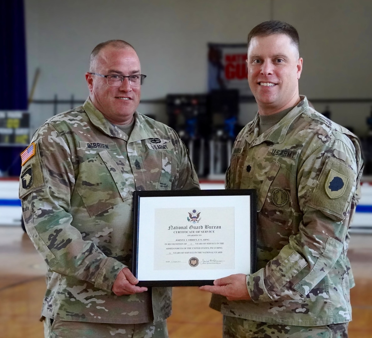 Command Sgt. Maj. Johnny O’Brien is presented the National Guard Bureau Certificate of Service by Lt. Col. Joseph Harris, Commander, Illinois Army National Guard (ILARNG) Recruiting and Retention Battalion (RRB), during a retirement ceremony June 9 at the Illinois Army National Guard armory in Dixon, Illinois. O’Brien served for 28 years in the ILARNG, most recently as the RRB’s senior enlisted leader.