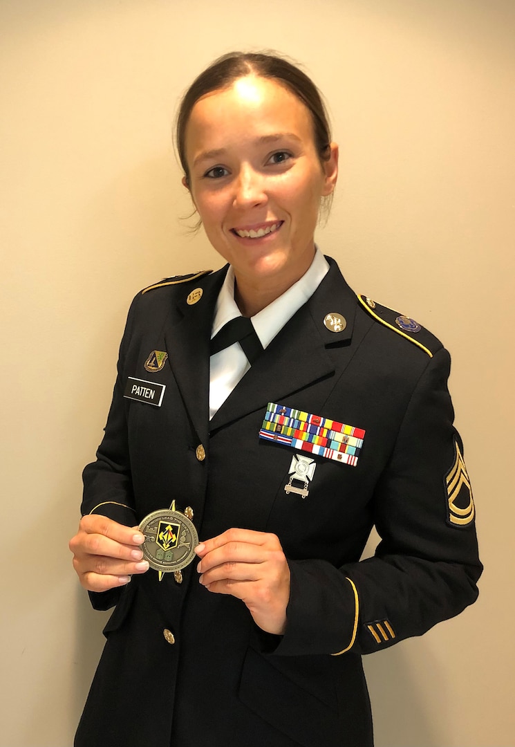 Illinois Army National Guard Sgt. 1st Class Mary Joan  Patten, a Chemical, Biological, Radiological, and Nuclear Specialist with Headquarters and Headquarters Company, 766th Brigade Engineer Battalion, based in Decatur, shows off a challenge coin she received for a job well done. On July 18, Patten will report to Fort Sill, Oklahoma, to compete in the All-Army Women’s Softball training camp as the only National Guard member. (Photo courtesy of Sgt. 1st Class Mary Joan Patten)