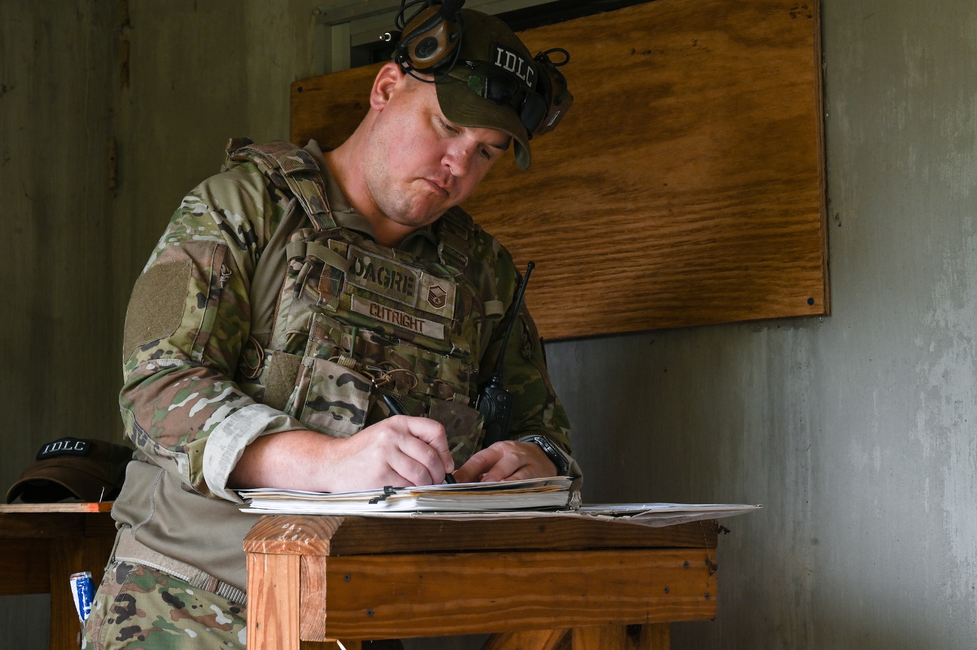 Master Sgt. Adam Cutright, the Integrated Defense Leadership Course assistant course chief assigned to the 919th Security Forces Squadron, Hurlburt Field, Florida, documents lot numbers for the detonation of live grenades on June 8, 2023, at Camp James A. Garfield Joint Military Training Center, Ohio.
