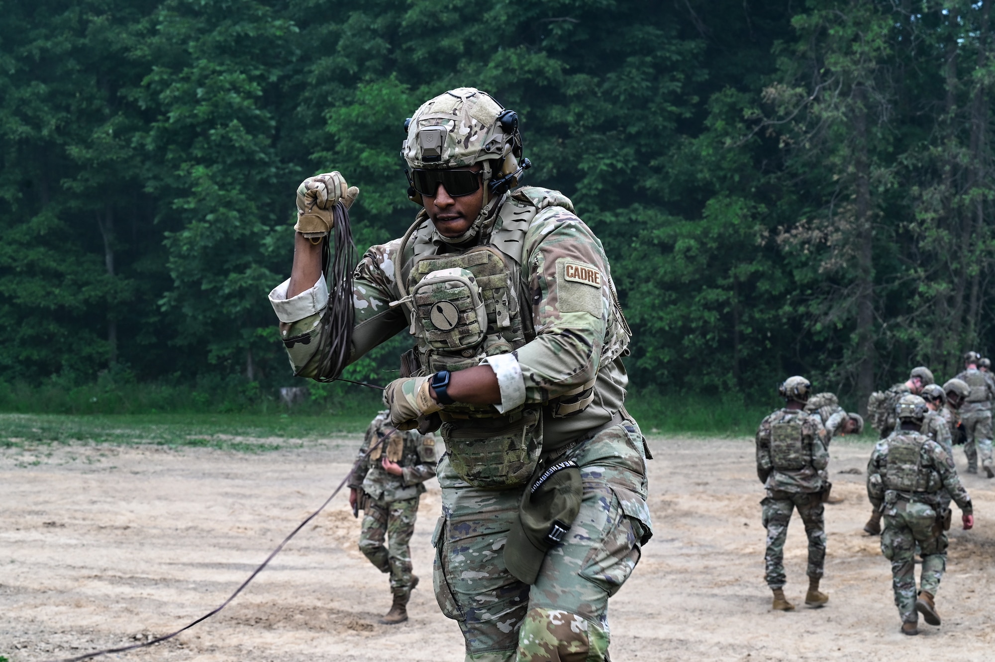 Staff Sgt. Daryn Weatherspoon, an Integrated Defense Leadership Course cadre member assigned to the 445th Security Forces Squadron, Wright-Patterson Air Force Base, Ohio, winds up detonation cord for claymores on June 8, 2023, at Camp James A. Garfield Joint Military Training Center, Ohio.