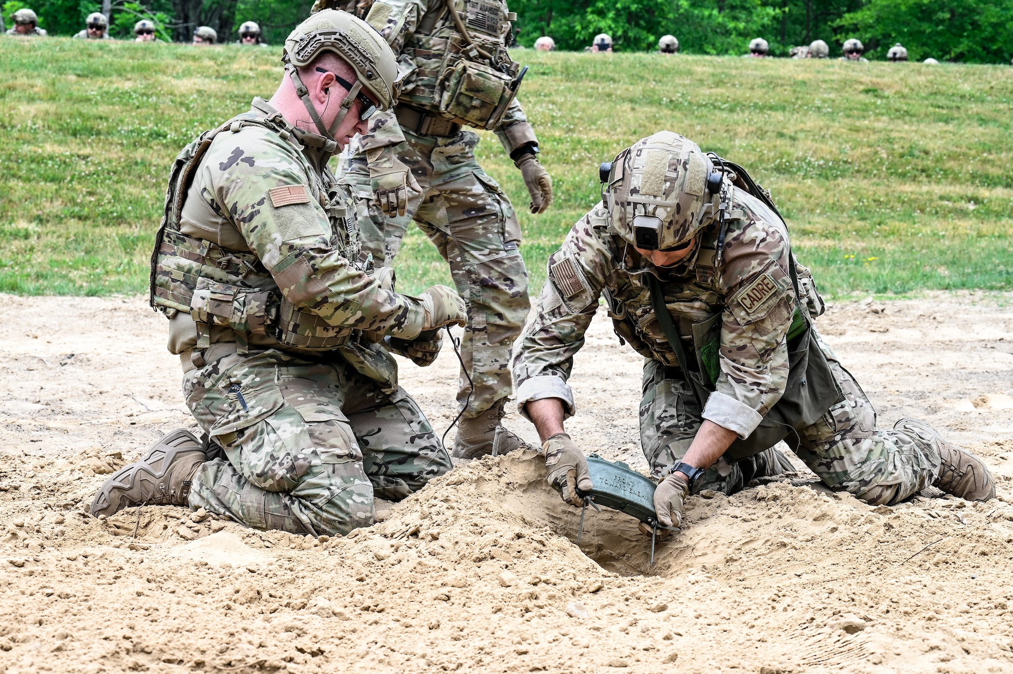 Senior Master Sgt. Daniel Chase, the Integrated Defense Leadership Course chief, and Staff Sgt. Ryan Cisneros, an IDLC cadre member, both assigned to the 310th Security Forces Squadron, Schriever Space Force Base, Colorado, prepare a claymore to be detonated on June 8, 2023, at Camp James A. Garfield Joint Military Training Center, Ohio.