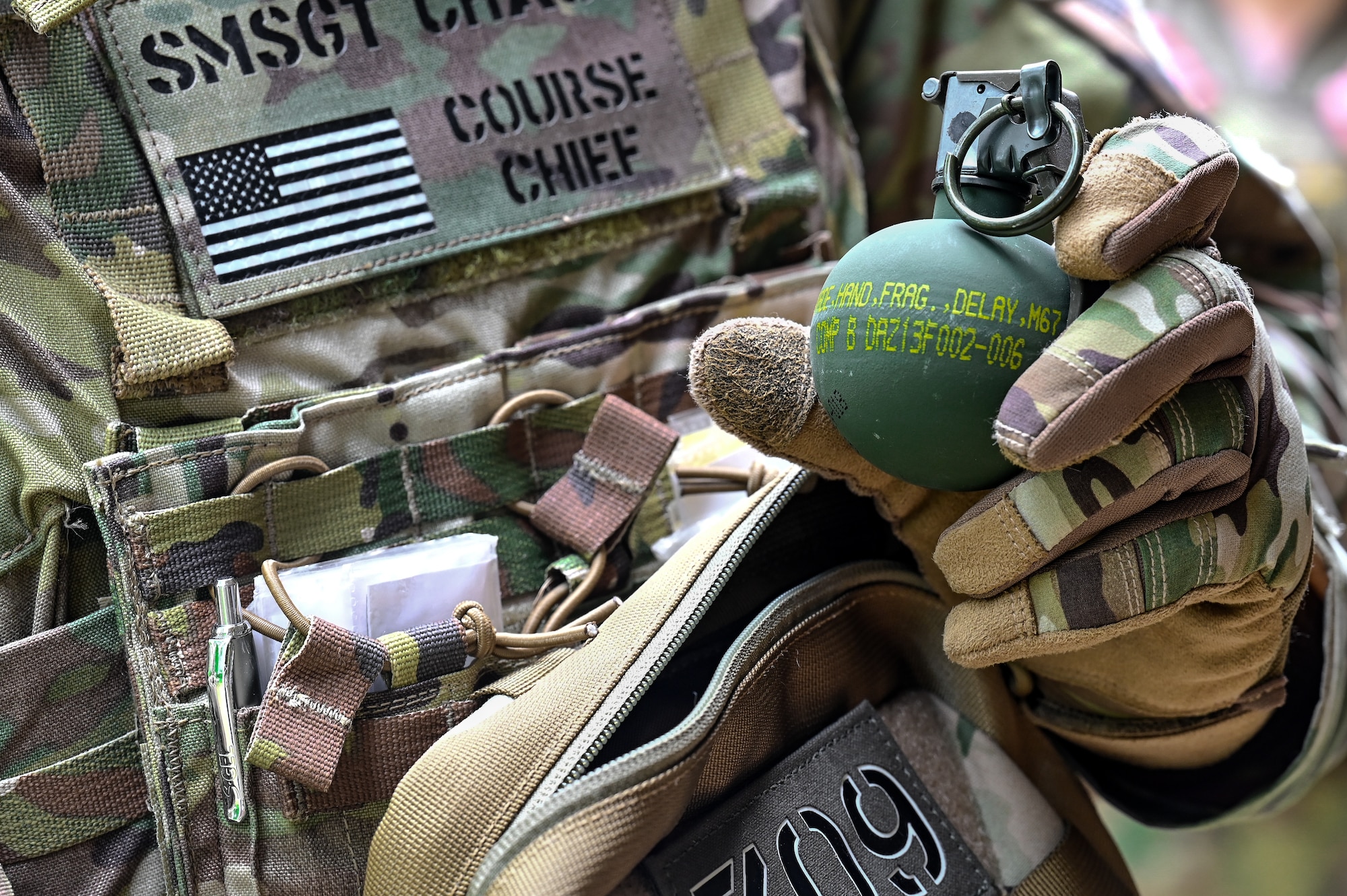Senior Master Sgt. Daniel Chase, the Integrated Defense Leadership Course chief assigned to the 310th Security Forces Squadron, Schriever Space Force Base, Colorado, holds a grenade on June 8, 2023, at Camp James A. Garfield Joint Military Training Center, Ohio.