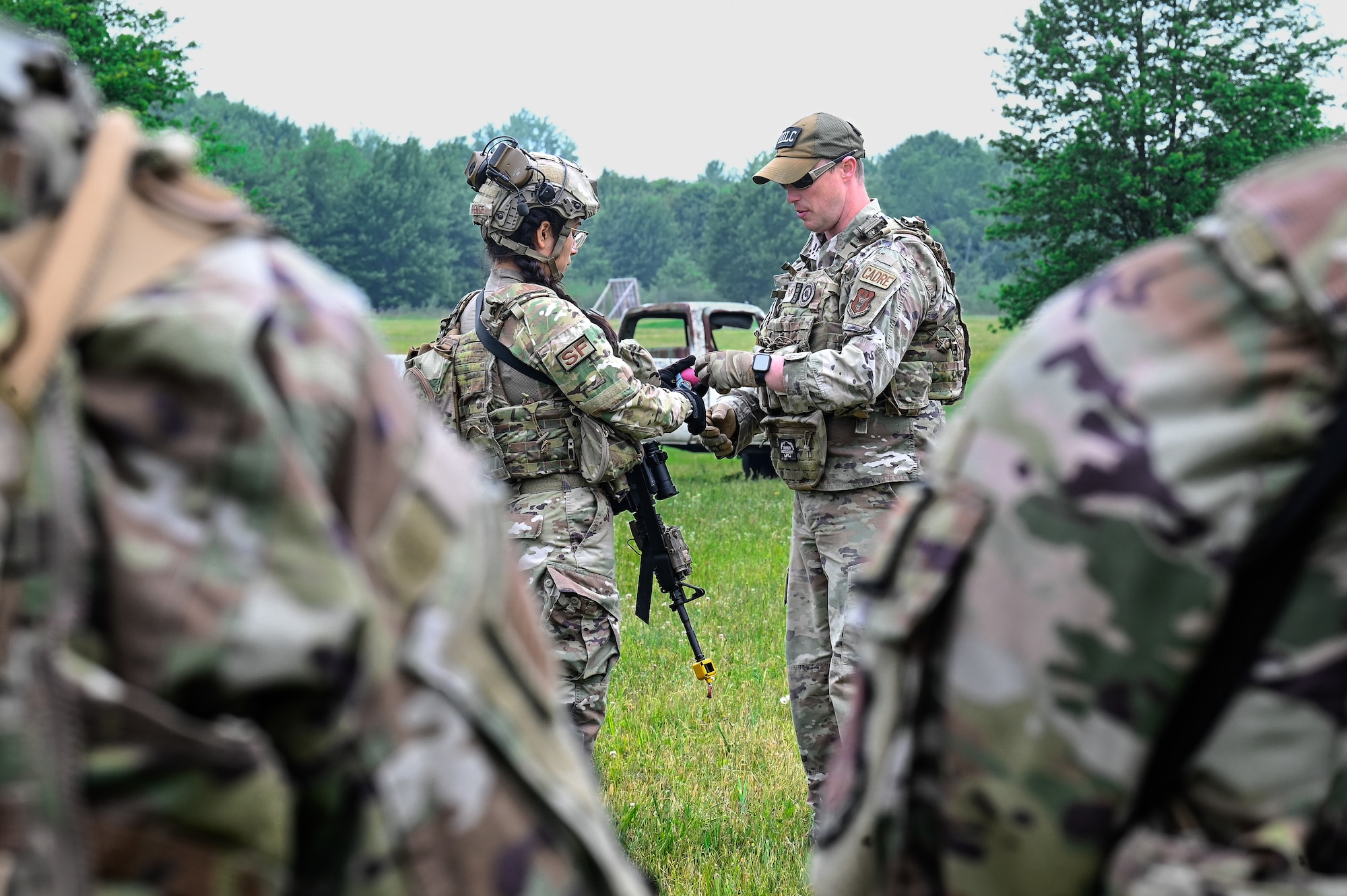 Staff Sgt. Brandon Wilkins, an Integrated Defense Leadership Course cadre member assigned to the 910th Security Forces Squadron, Youngstown Air Reserve Station, Ohio, teaches Airmen how to throw a practice grenade on June 8, 2023, at Camp James A. Garfield Joint Military Training Center, Ohio.