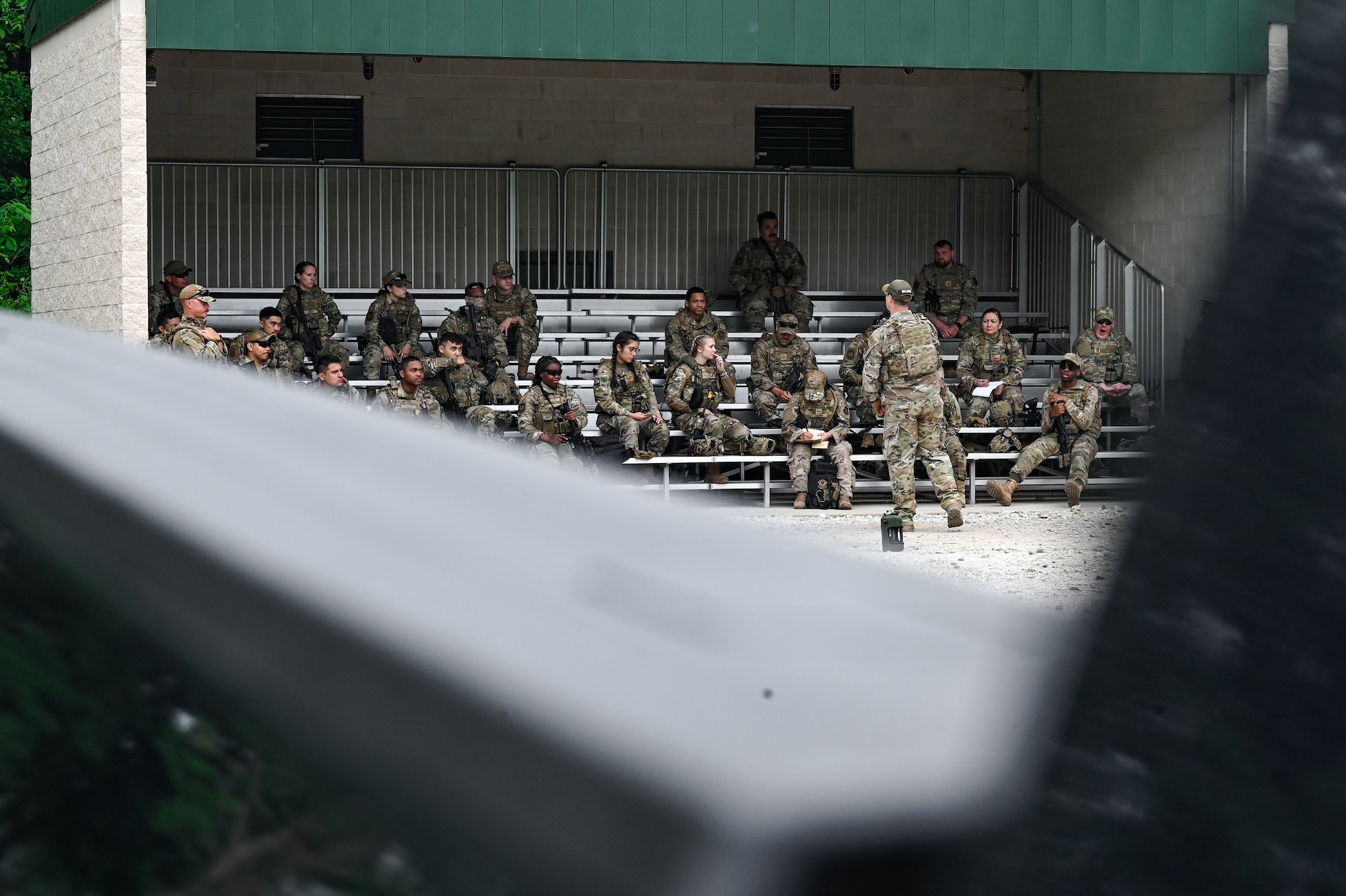 Staff Sgt. Brandon Wilkins, an Integrated Defense Leadership Course cadre member assigned to the 910th Security Forces Squadron, Youngstown Air Reserve Station, Ohio, instructs Defenders how to throw a practice grenade on June 8, 2023, at Camp James A. Garfield Joint Military Training Center, Ohio.