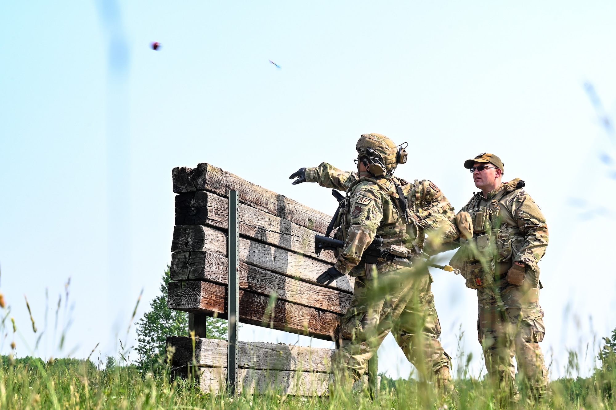 Senior Airman Nicholas Lozano, a Defender with the 301st Security Forces Squadron, Carswell Field, Naval Air Station Joint Reserve Base Fort Worth, Texas, throws a practice grenade during training on June 7, 2023, at Camp James A. Garfield Joint Training Center, Ohio.