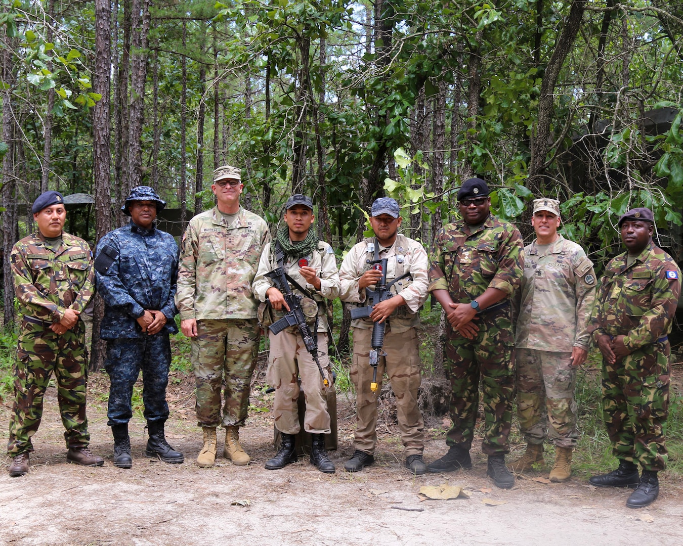 Maj. Gen. Keith Waddell, Louisiana National Guard adjutant general, and Command Sgt. Maj. Clifford J. Ockman Jr., Louisiana National Guard senior enlisted advisor, with service members from Belize during a visit to the Joint Readiness Training Center at Fort Johnson in Leesville, La., June 6, 2023.  Louisiana and Belize have been partnered together as part of the State Partnership Program since 1996.