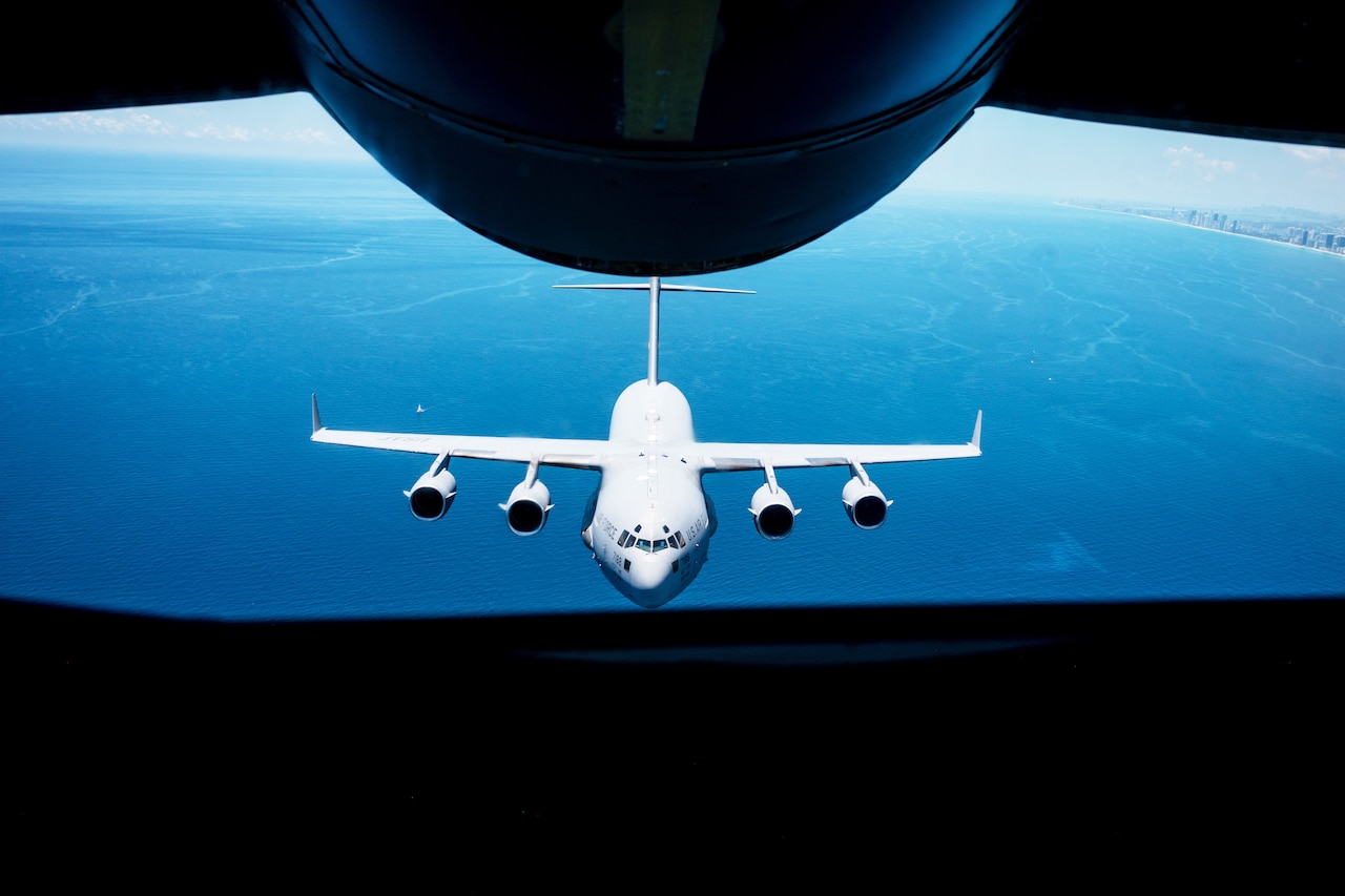 A large aircraft is seen from the rear of another aircraft.