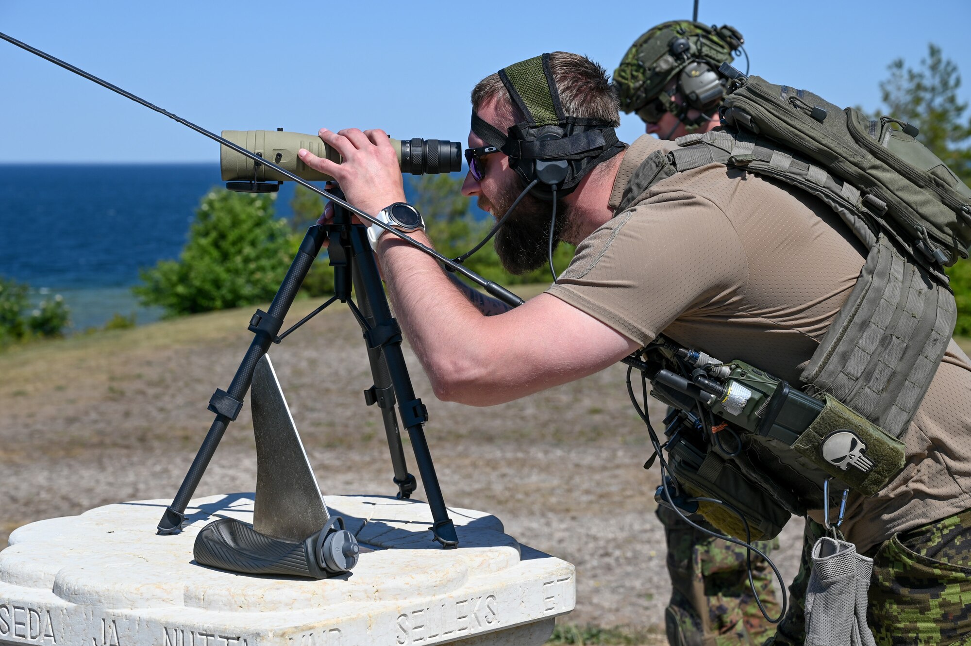 Estonian air force Master Sgt. M. Aavik, a joint terminal attack controller assigned to the Estonian air force air support operations squadron, surveys targets for a live missile firing at a water range off the coast of Saaremaa, Estonia, June 12, 2023.