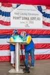 Mrs. Elizabeth Asher, Point Loma (EPF 15) sponsor, welds her
initials onto the keel plate as the honorary keel authenticator at the EPF 15 keel laying ceremony on June 27, 2023.  She was assisted by Mr. Perry Sullivan, an Austal USA A-Class welder.