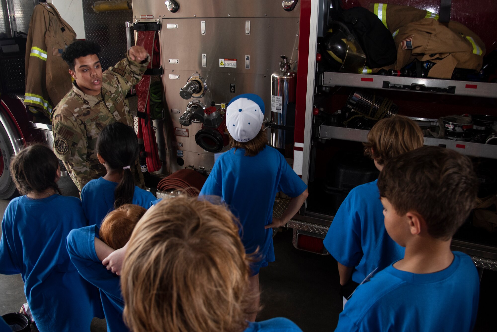 Senior Airman Marwane Hsaini, 4th Civil Engineer Squadron firefighter, explains the functions of a fire truck to Wayne County students during an Aerospace Camp community engagement event at Seymour Johnson Air Force Base, North Carolina, June 20, 2023. During the event, 36 students were able to visit various locations on base including the 4th CES fire department, 4th Fighter Wing Aircrew Flight Equipment section, 4th Operations Squadron base operations and weather flight, and the installation’s flightline. Community events like this help strengthen the partnership shared between the base and local community, and develop our youth to progress as future leaders. (U.S. Air Force photo by Tech. Sgt. Christopher Hubenthal)