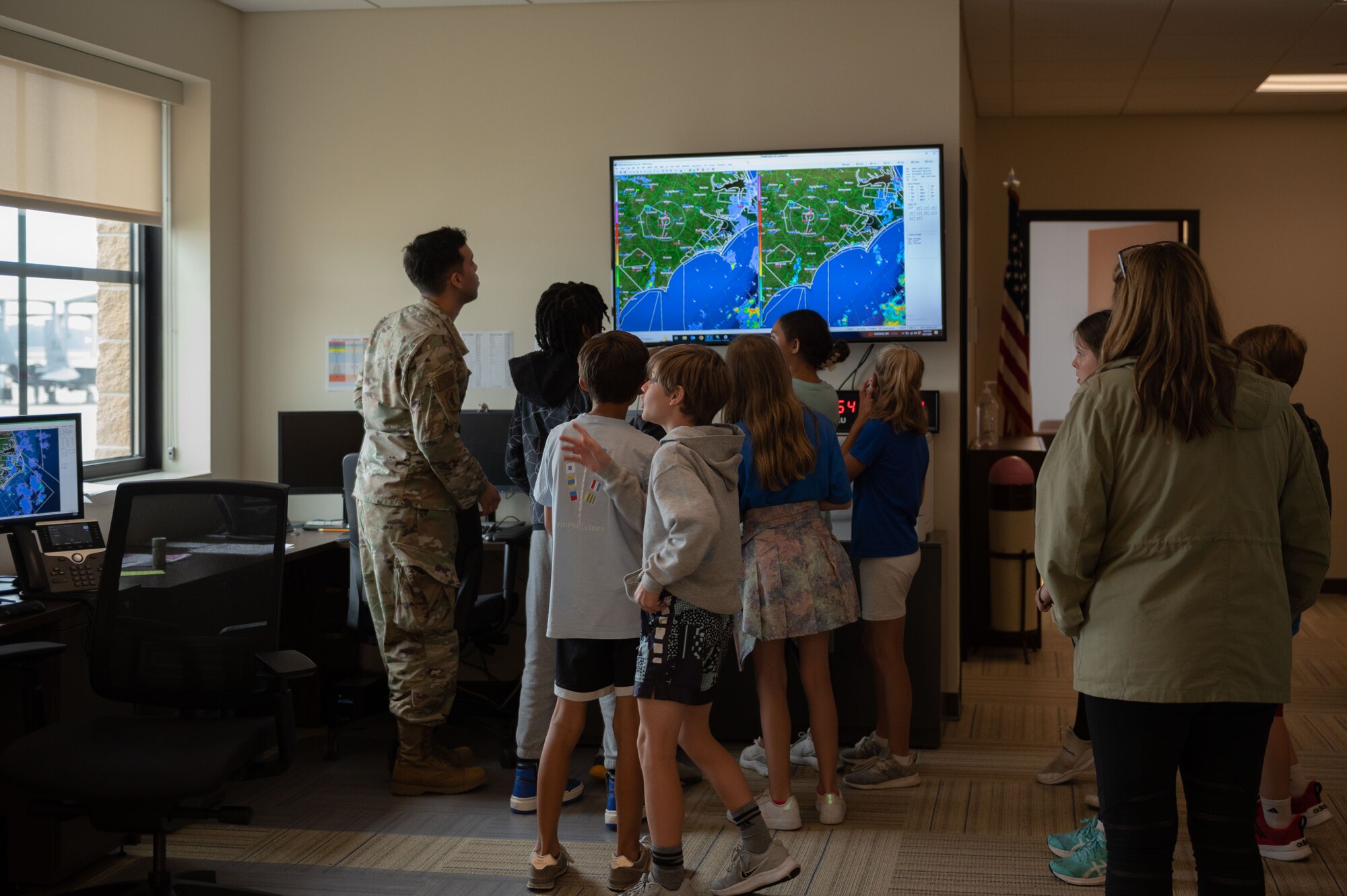 U.S. Air Force Senior Airman Randy Diaz, 4th Operation Support Squadron weather journeyman, shows Wayne County students how the weather is read on a radar during an Aerospace Camp community event at Seymour Johnson Air Force Base, North Carolina, June 22, 2023. The Aerospace Camp gave students an opportunity to meet Airmen who use science, technology, engineering and math (STEM) when performing their mission, and tour locations on base to learn how Team Seymour contributes to the Air Combat Command and U.S. Air Force mission. (U.S. Air Force photo by Airman 1st Class Rebecca Sirimarco-Lang)