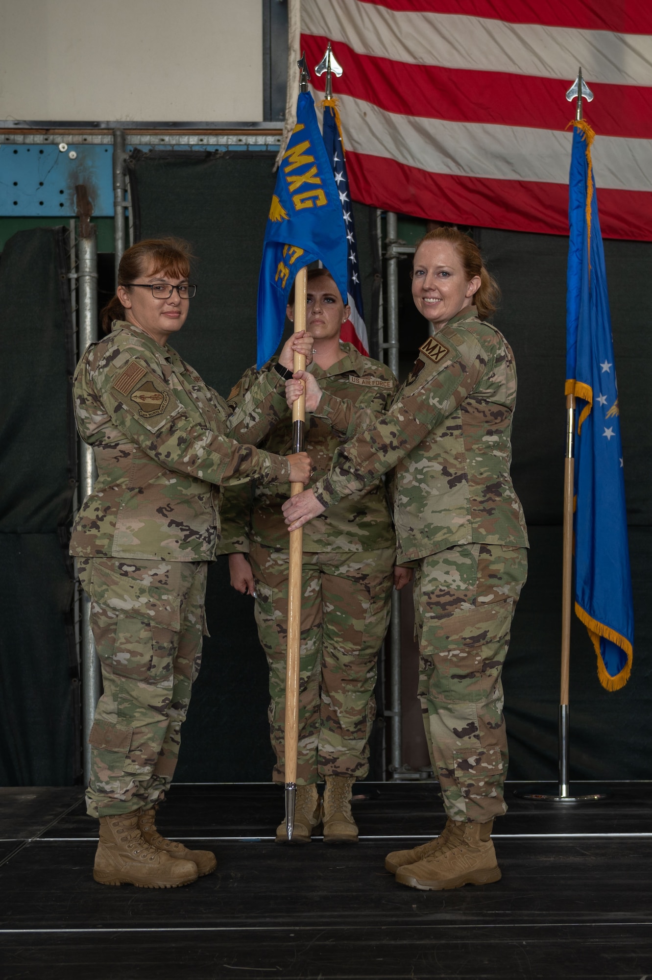 U.S. Air Force Maj. Madison Gilbert, left, incoming 335th Fighter Generation Squadron commander, accepts the guidon of U.S. Air Force Col. Kathryn Roman, left, 4th Maintenance Group commander, during a change of command ceremony at Seymour Johnson Air Force Base, North Carolina, June 23, 2023. Base and community leadership, along with friends and family of the squadron’s incoming and outgoing commanders, gathered to witness the traditional passing of the guidon. (U.S. Air Force photo by Airman 1st Class Rebecca Sirimarco-Lang)
