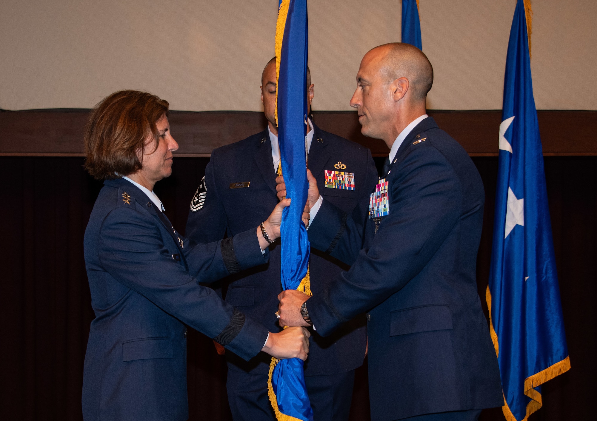 Col. Damian Schlussel assumes command by accepting the Thomas N. Barnes Center for Enlisted Education organizational flag from Lt. Gen. Andrea D. Tullo, Air University commander and president, during a change of command ceremony at the Senior Noncommissioned Officer Academy on Maxwell Air Force Base - Gunter Annex, June 28, 2023. (U.S. Air Force photo/Brian Ferguson)