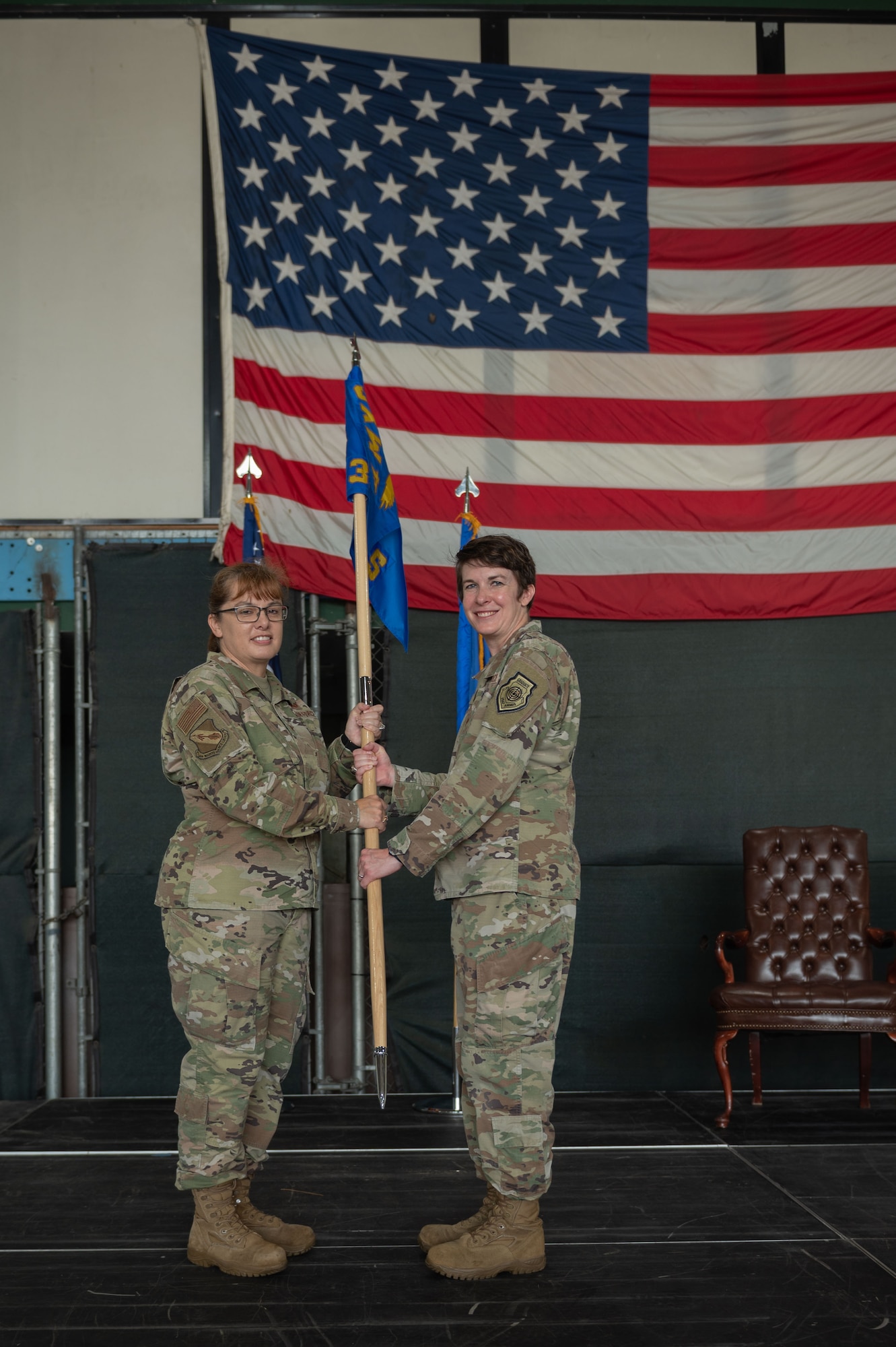Maj. Lauren Kruse, left, incoming 333rd Fighter Generation Squadron commander, accepts the guidon of Col. Kathryn Roman, left, 4th Maintenance Group commander, during a change of command ceremony at Seymour Johnson Air Force Base, North Carolina, June 23, 2023. Base and community leadership, along with friends and family of the squadron’s incoming and outgoing commanders, gathered to witness the traditional passing of the guidon. (U.S. Air Force photo by Airman 1st Class Rebecca Sirimarco-Lang)