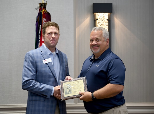 Douglas Saxon, deputy chief of Construction Division for the U.S. Army Corps of Engineers, Savannah District, is congratulated by Savannah Commander Col. Joseph Geary following an awards ceremony, June 27, where Saxon was honored with the 2023 James B. Connolly Award during the Society of American Military Engineers Annual Program Review. The award is presented annually to a civilian or military engineer for notable contributions in the field of engineering.